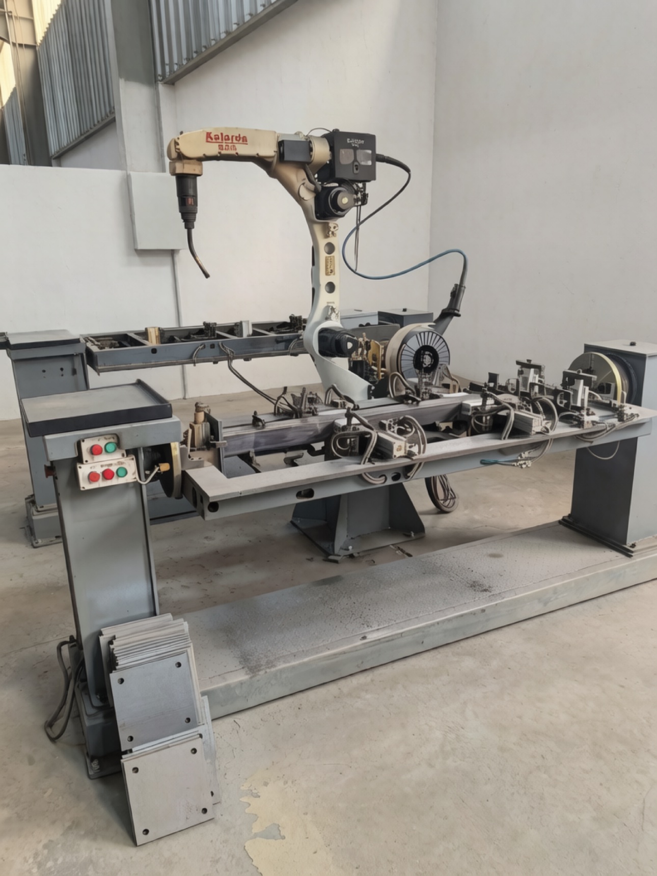Robotic welding arm at a welding workstation